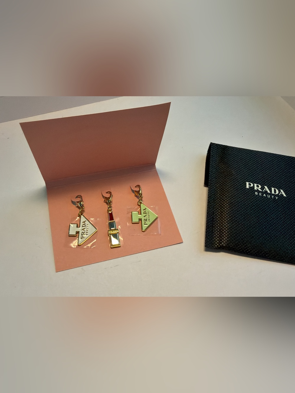 New,authentic Prada beauty Pink Enamel & Gold-Tone Mini Charm Keychain Trio.